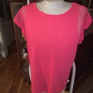 Pink Xersion workout top with mesh accents.